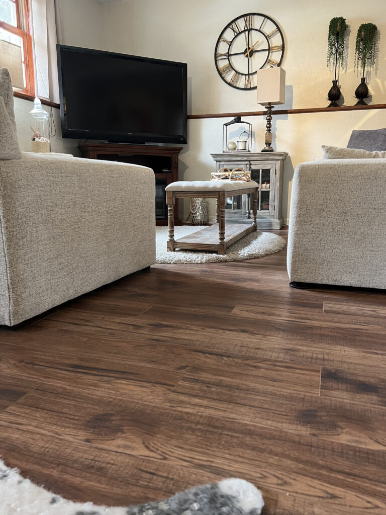 Continuous dark flooring across an adjoining room