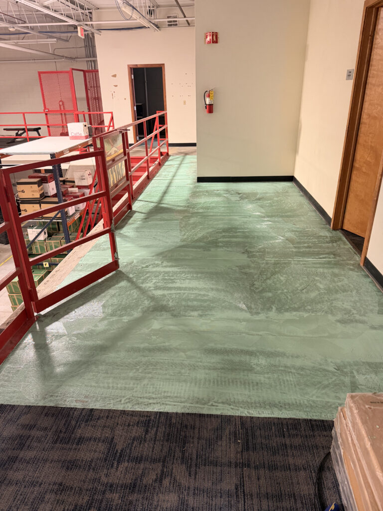 Prepared room receiving new plank flooring