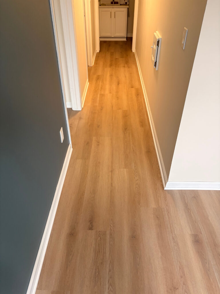 Finished flooring carried through an adjoining doorway