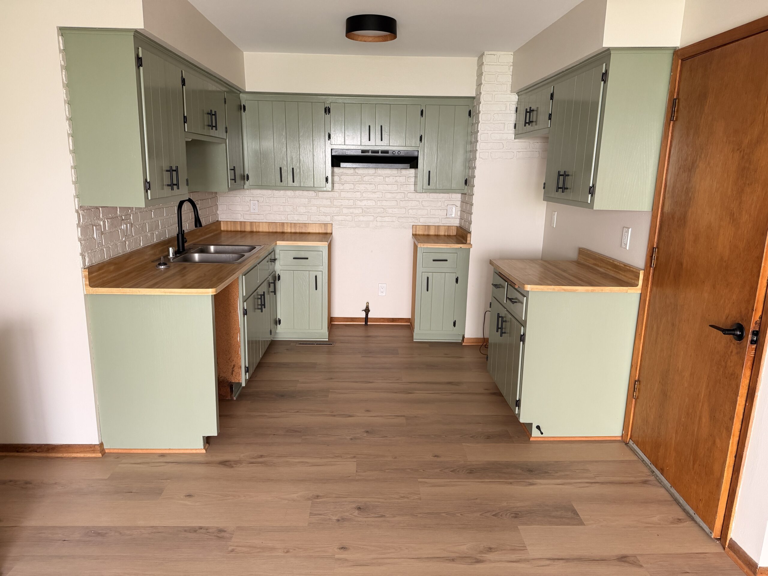 Maple-look LVP running from the kitchen into the adjoining room