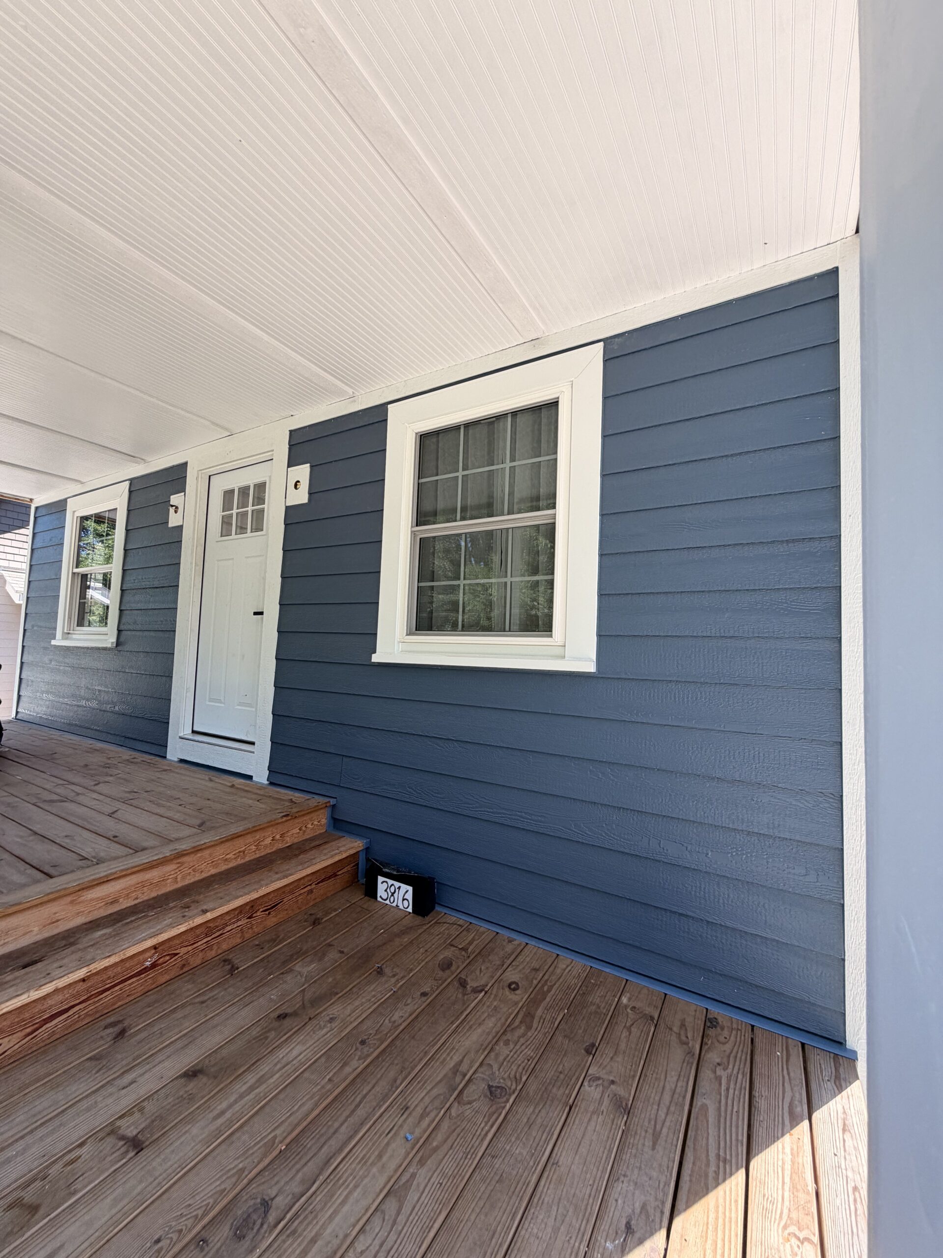 White entry door, casing, and porch trim