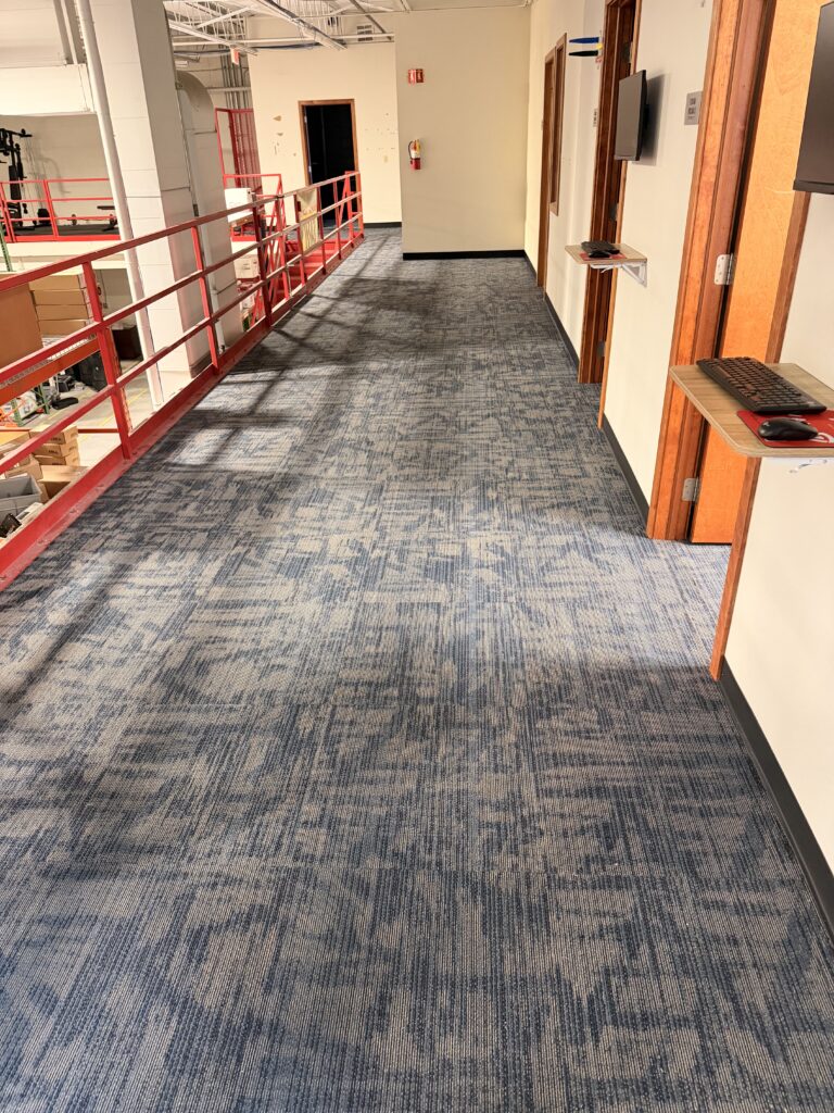 Completed blue patterned carpet tile installation in a commercial interior