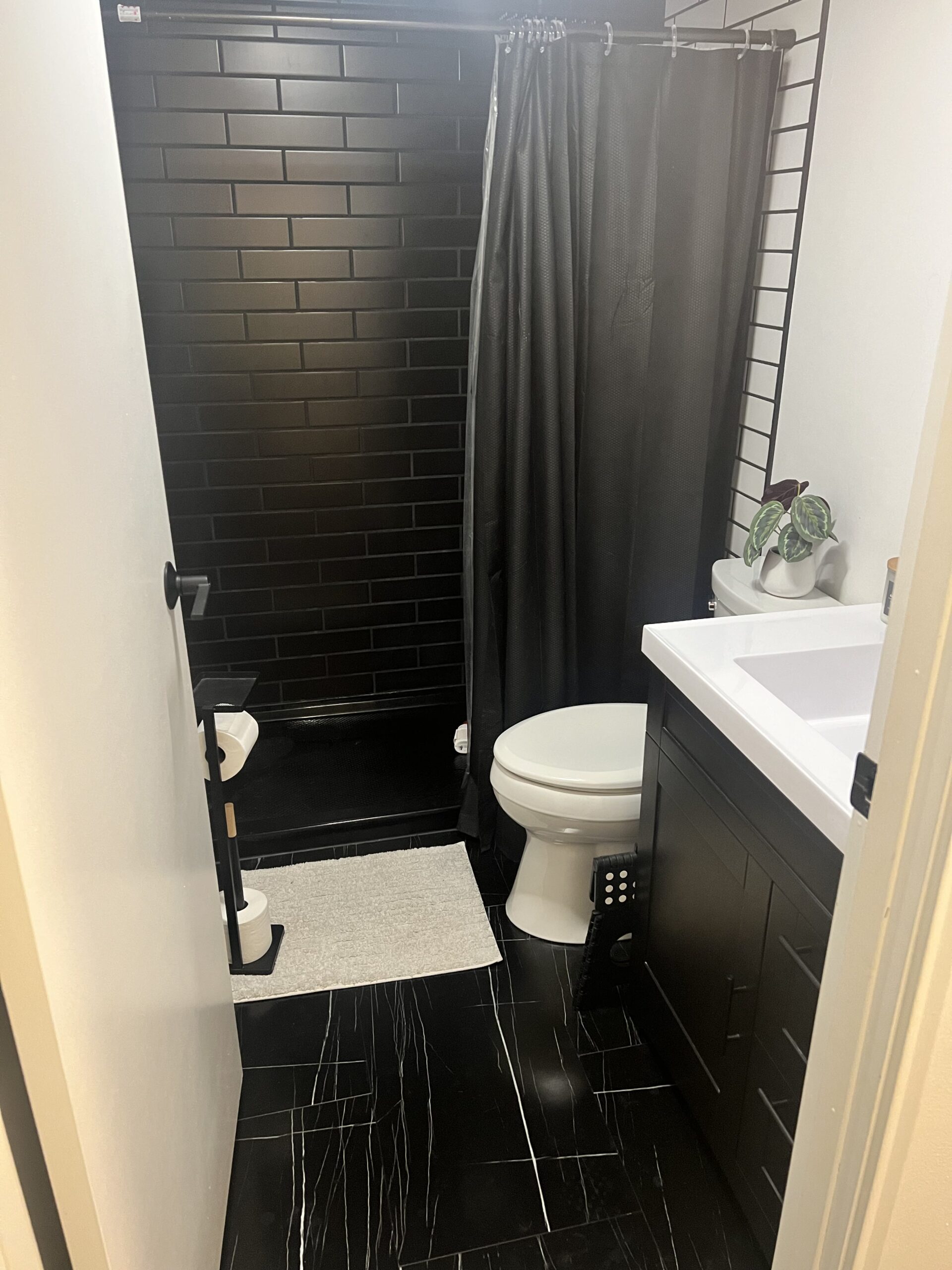 Black marble-look LVT tile bathroom floor