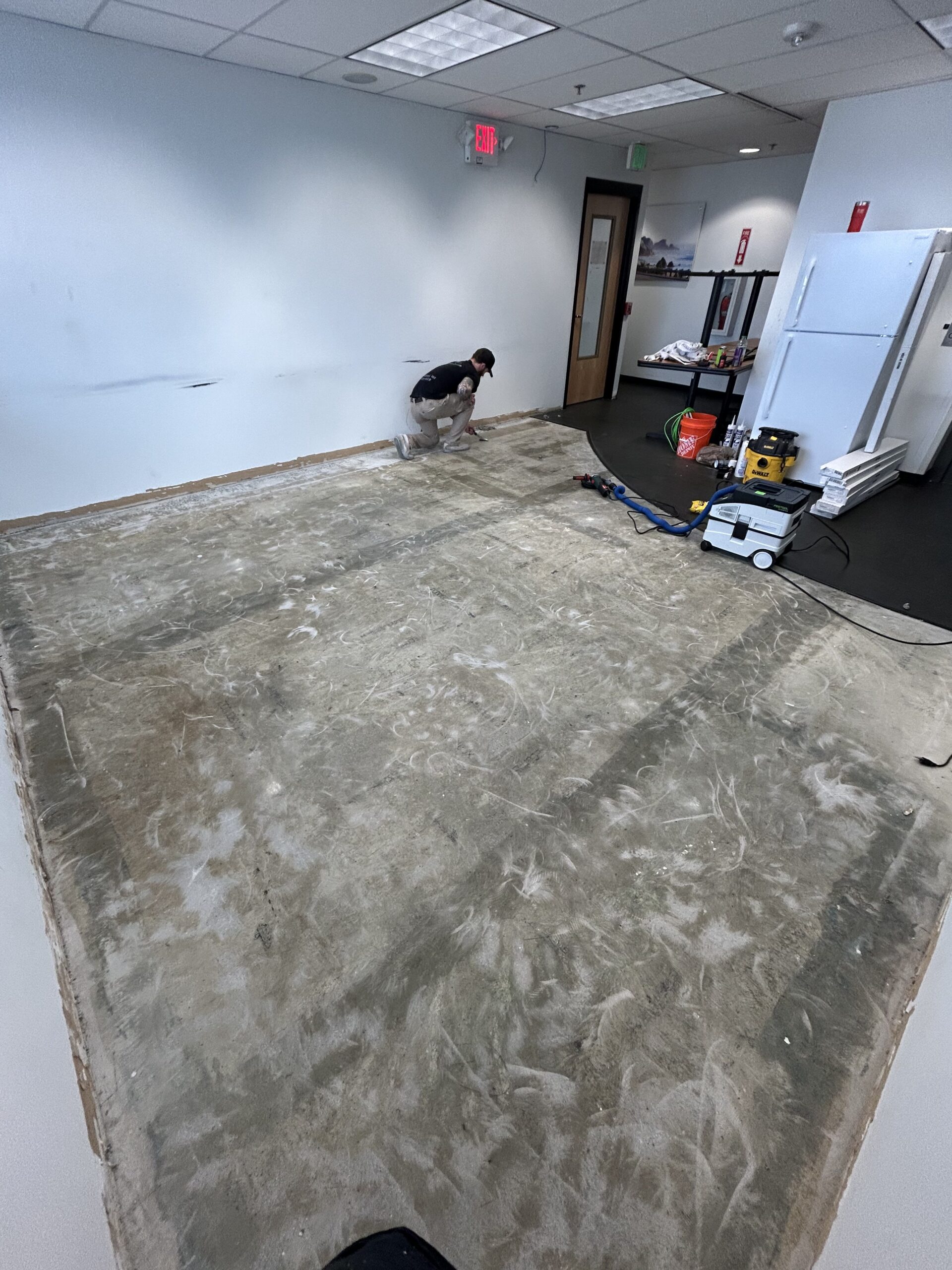 Concrete surface prepared for glue-down LVP at Mercedes-Benz