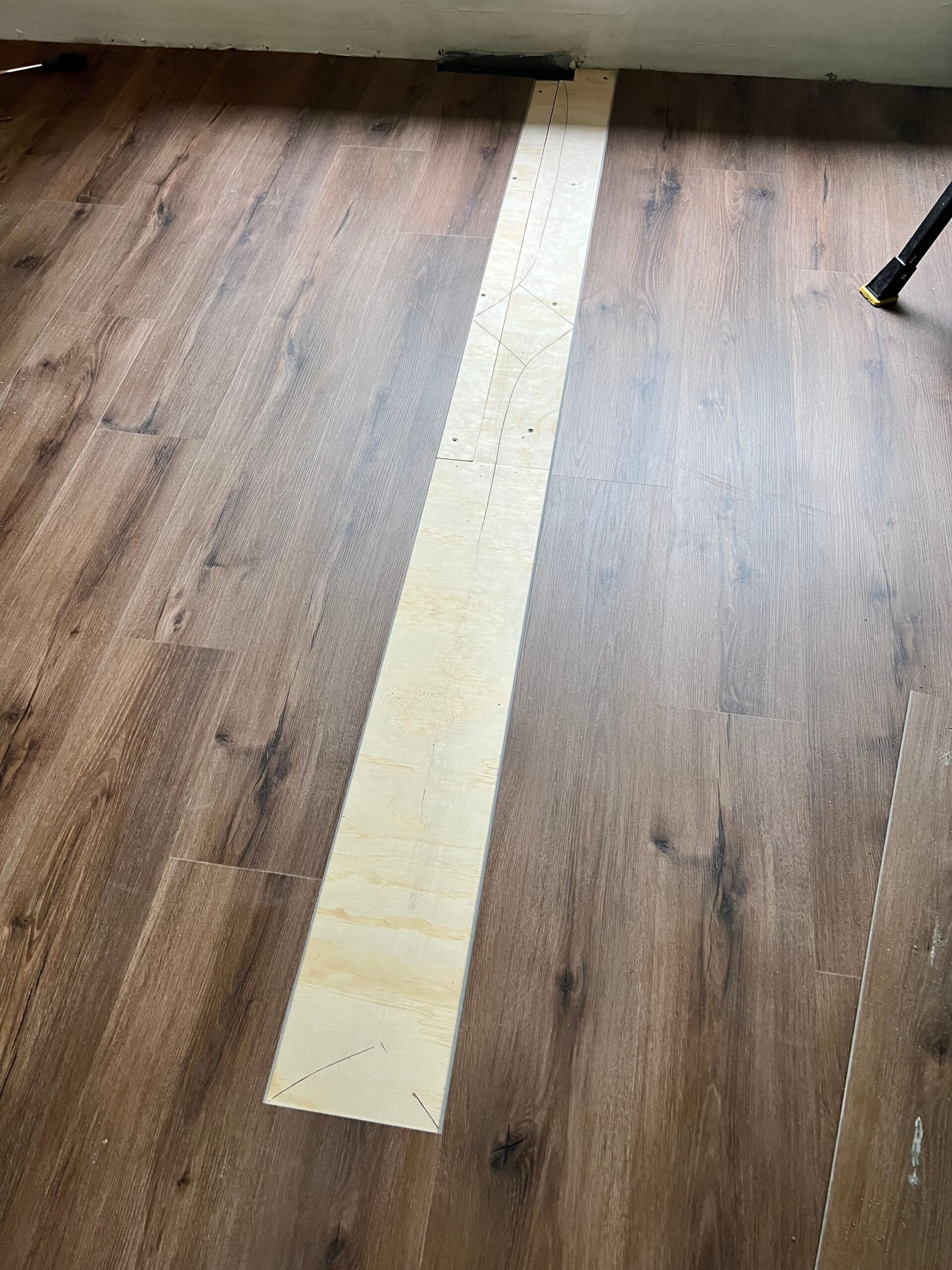 New plank going down over a prepared floor